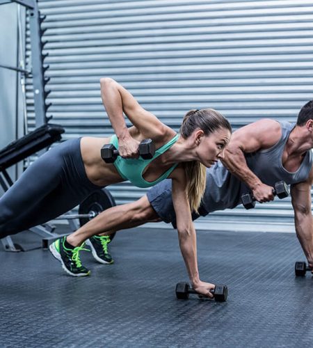 muscular-couple-doing-plank-exercise-together